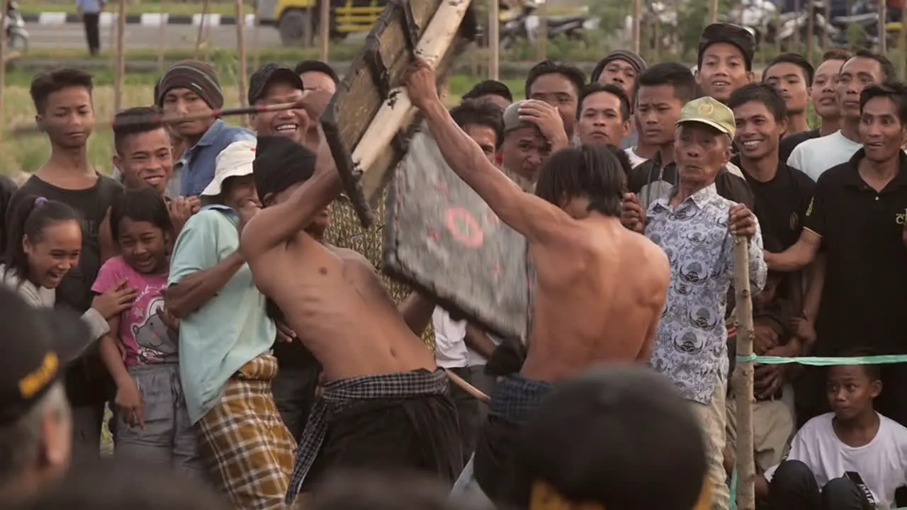 Indonesian Men Fighting With Sticks and Shields