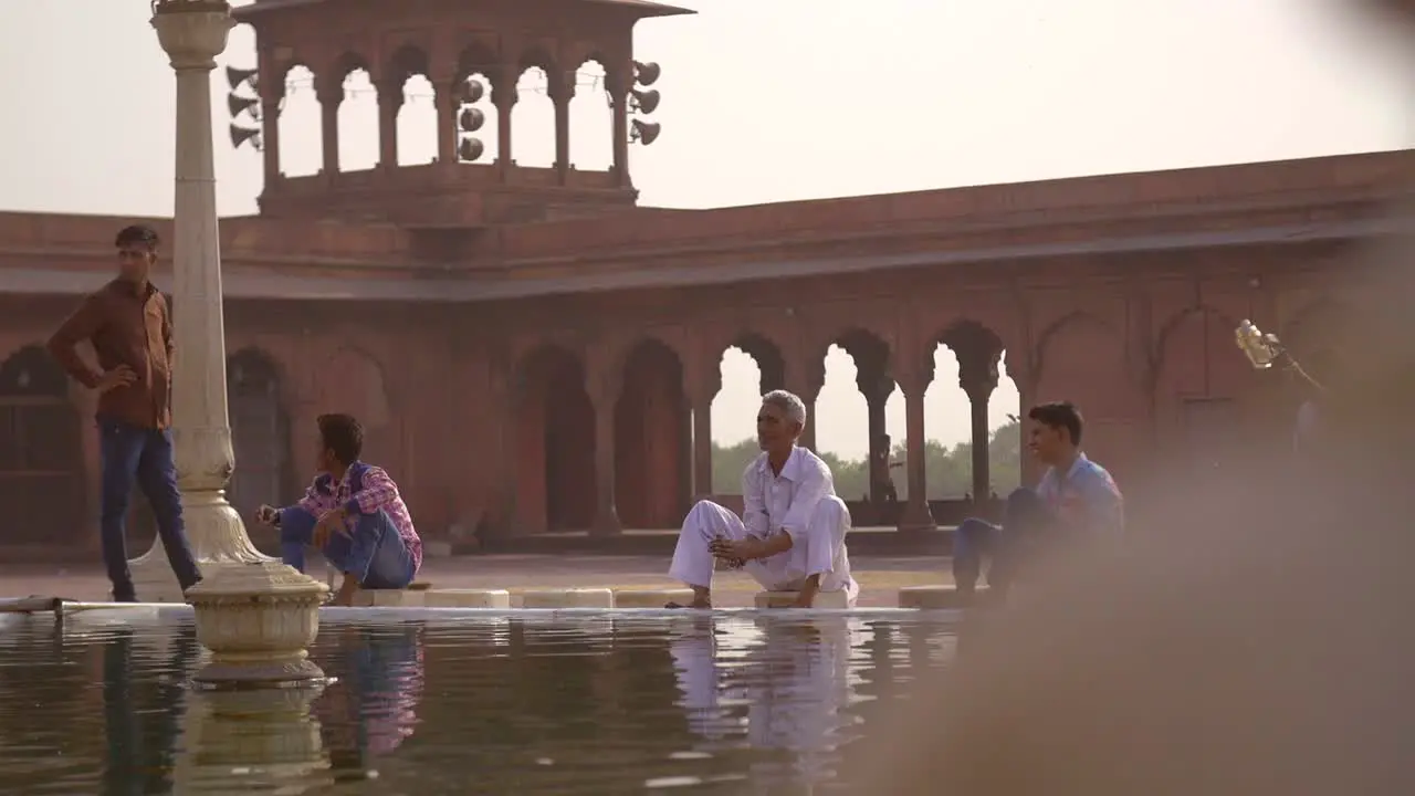 Reveal Shot of People Bathing at Jama Masjid