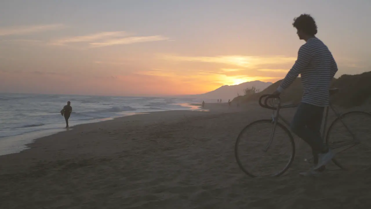 Man With Bike On The Beach Beautiful Sunset Landscape