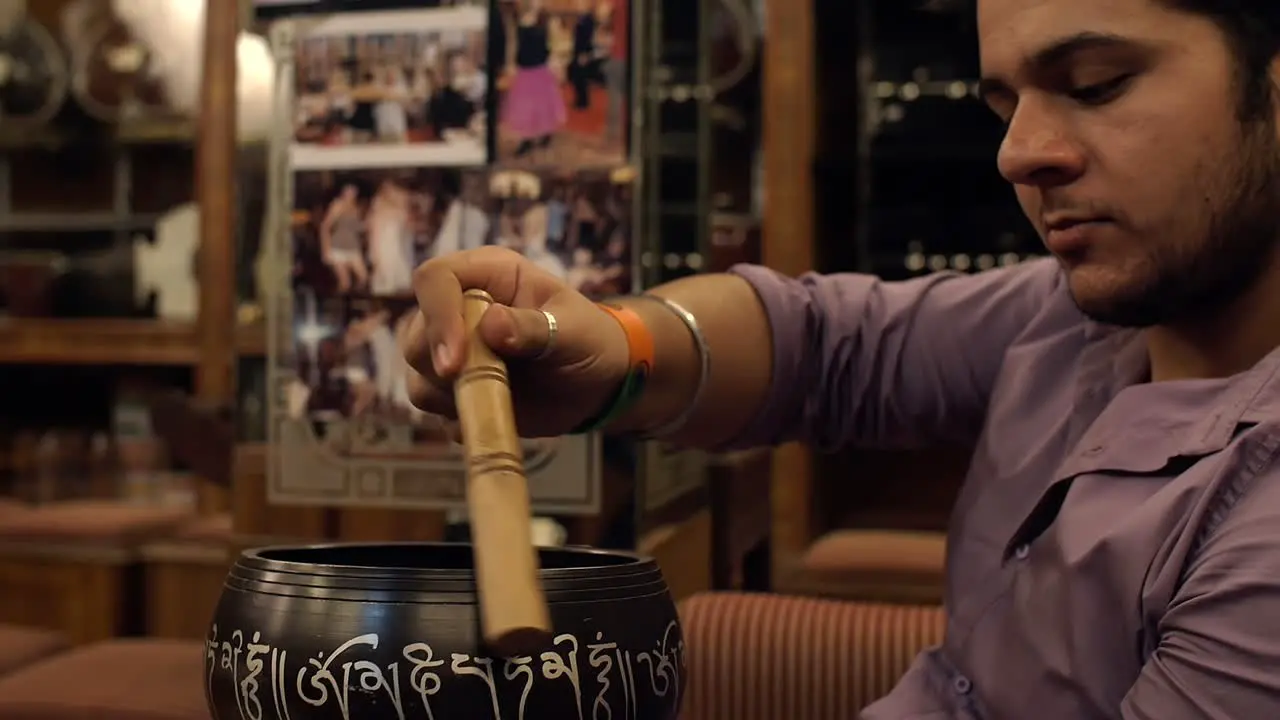 Man Playing a Singing Bowl