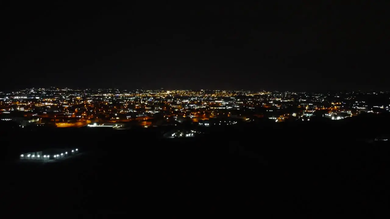 Aerial flying forward over Jeddah during nighttime