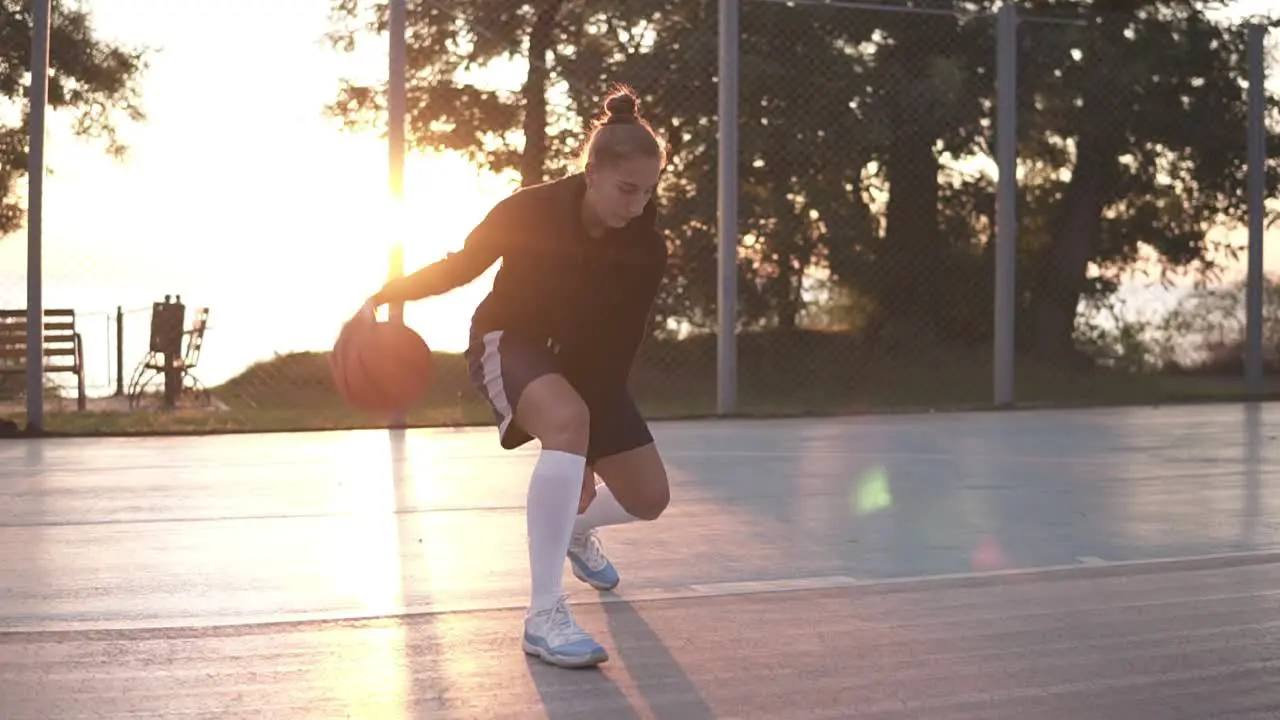 Close Up Footage Of A Young Girl Basketball Player Training And Exercising Outdoors On The Local Court 3