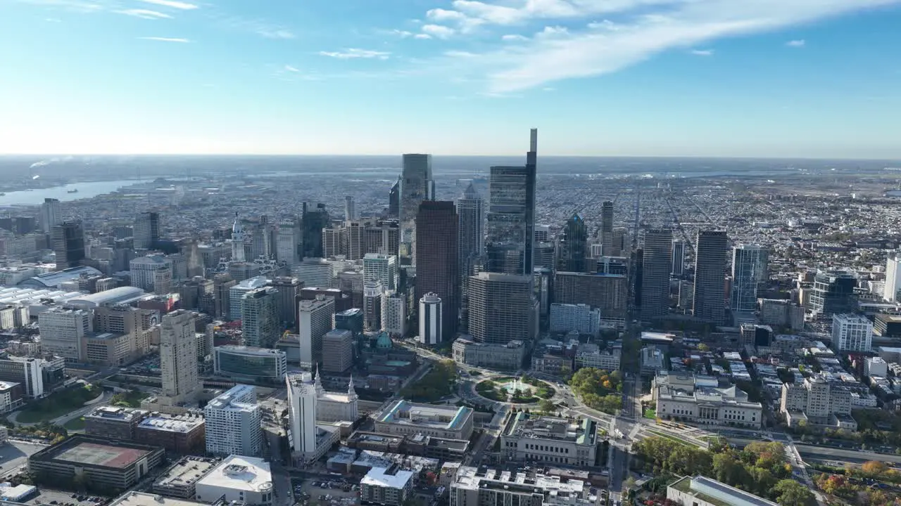 Aerial footage of the skyline of downtown Philadelphia showing the traffic on the highway and the morning clouds in the background