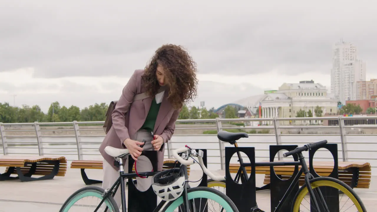 Pretty Woman In Formal Clothes Parking Her Bike On The City Bridge While Going To Work