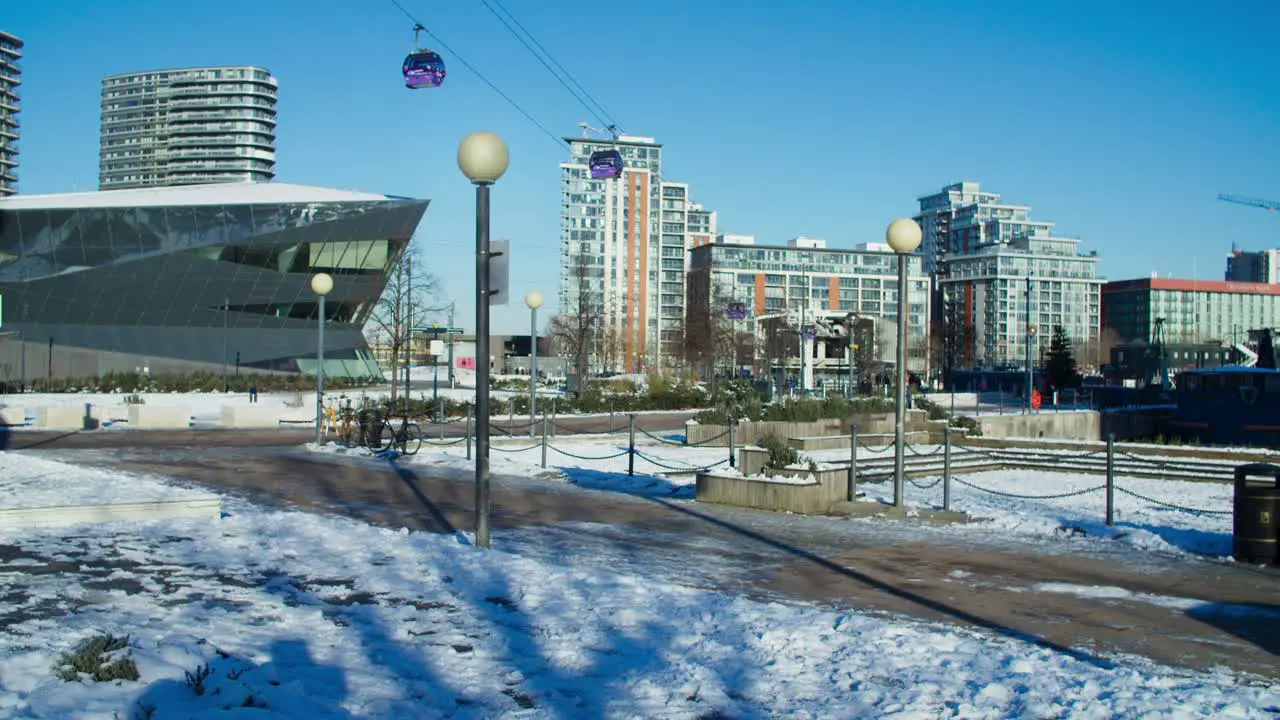 Static shot of cable cars at London Royal Docks on a snowy winter morning