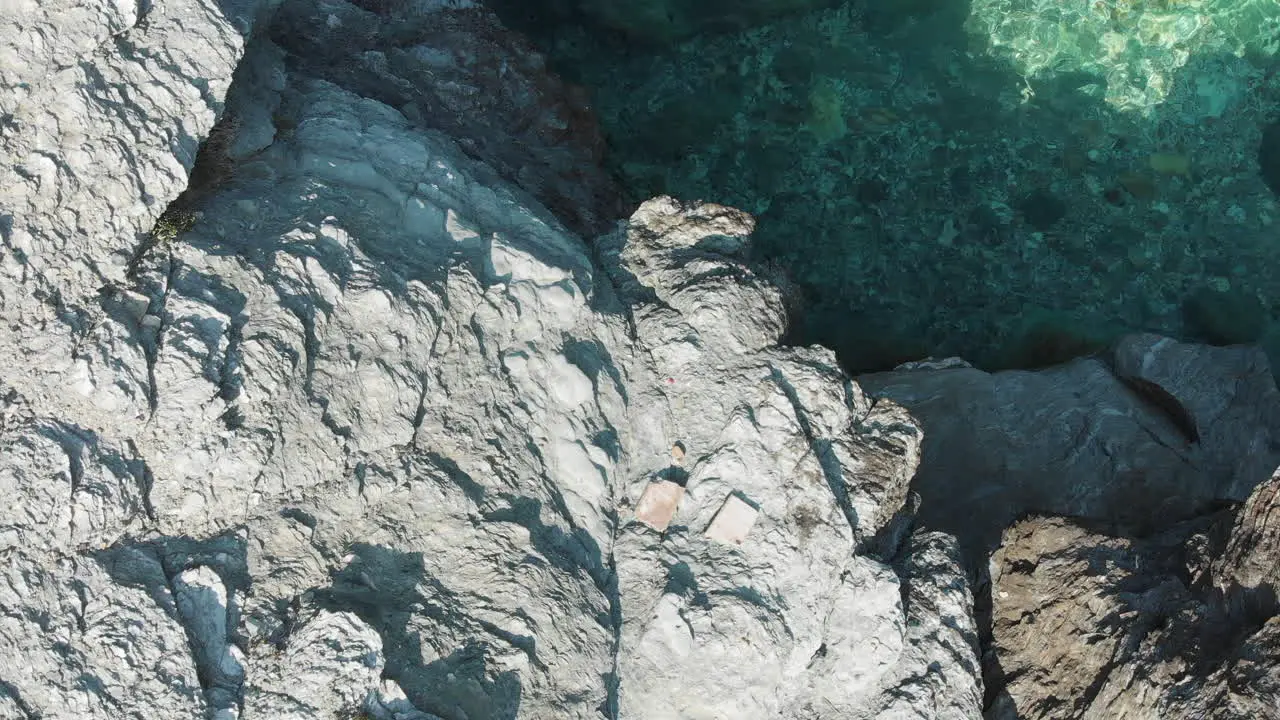 Slow fly over rocks at Mourtias beach Greece