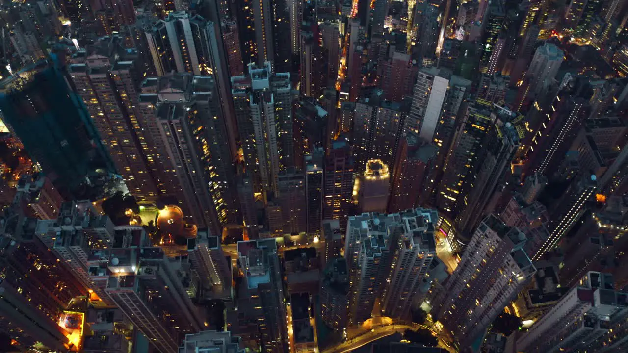 Drone shot of a city full of skyscrapers during the night a lot of roads with busy traffics