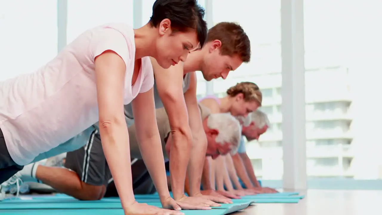 Exercise class doing push ups together