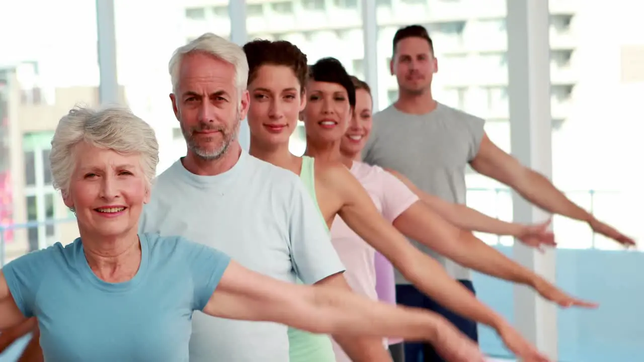 Yoga class stretching out their arms