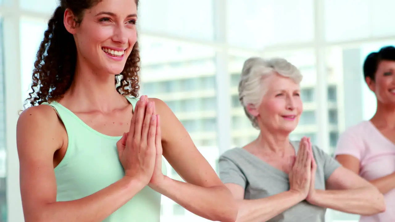 Women at a yoga class in tree pose pose