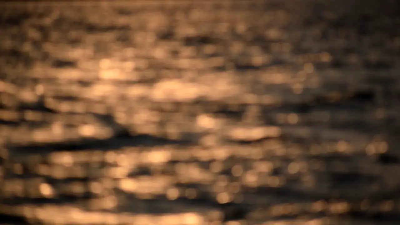 Waves passing by at dawn with beautiful bokeh balls in Desenzano Garda Lake North Italy