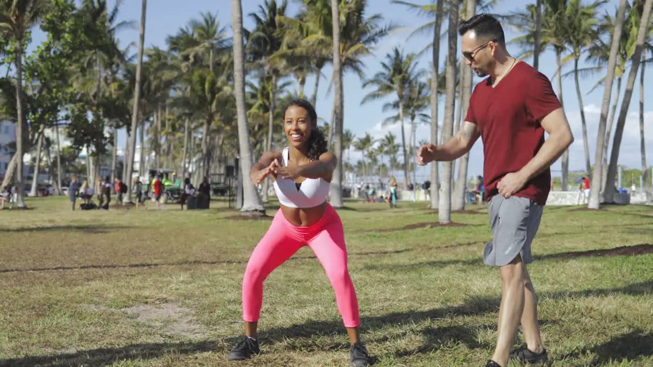 Girl training with man in park