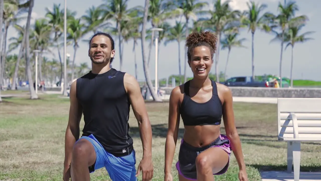 Smiling couple exercising with legs up