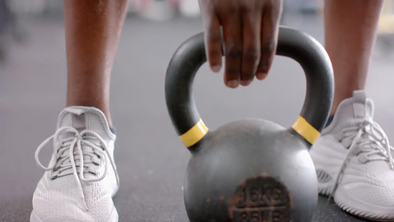 Close-up of athletic shoes and a kettlebell at the gym