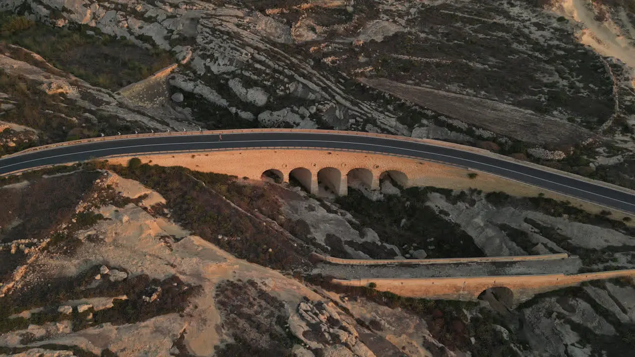 Aerial Footage of a runner crossing a bridge