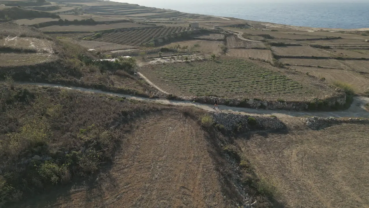 Aerial Footage of a runner male jogging in malta