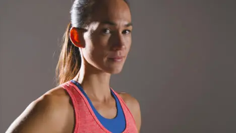 Close Up Shot of a Young Woman Looking at Camera at Gym