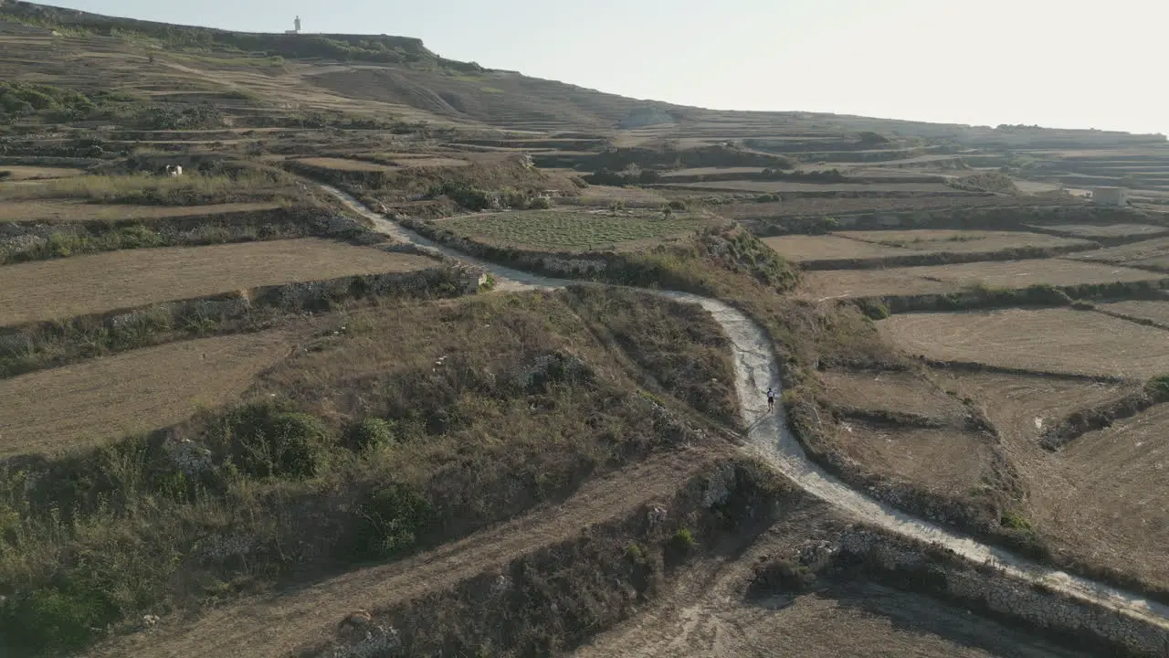 Aerial Footage of a runner male jogging in Gozo