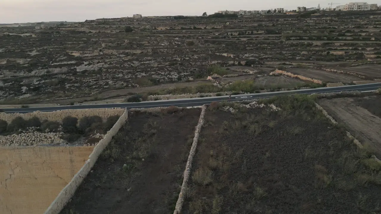 Aerial Footage of a runner male jogging at sunset