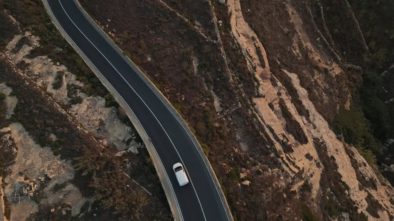 Aerial Top View Of A Man Running jogging man in sunset while car is passing