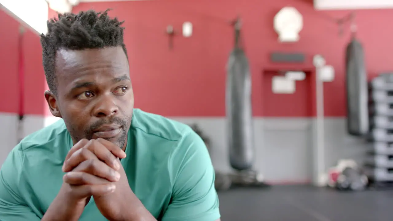 Fit African American man in a gym setting with copy space