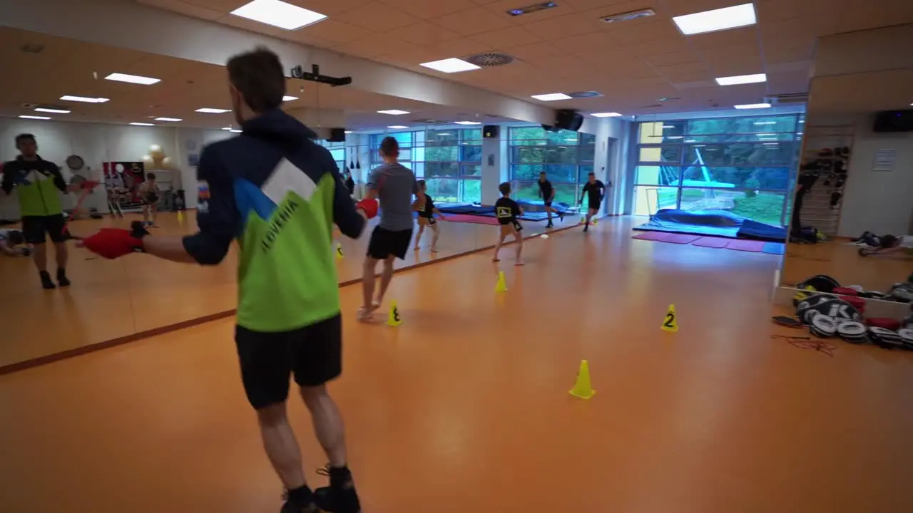 A group of people are exercising and jumping rope in a gym