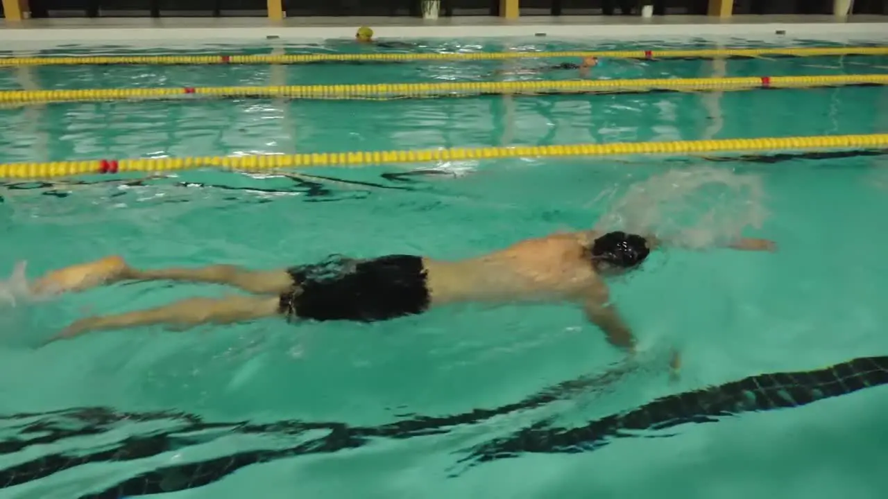 The man was exercising in the swimming pool