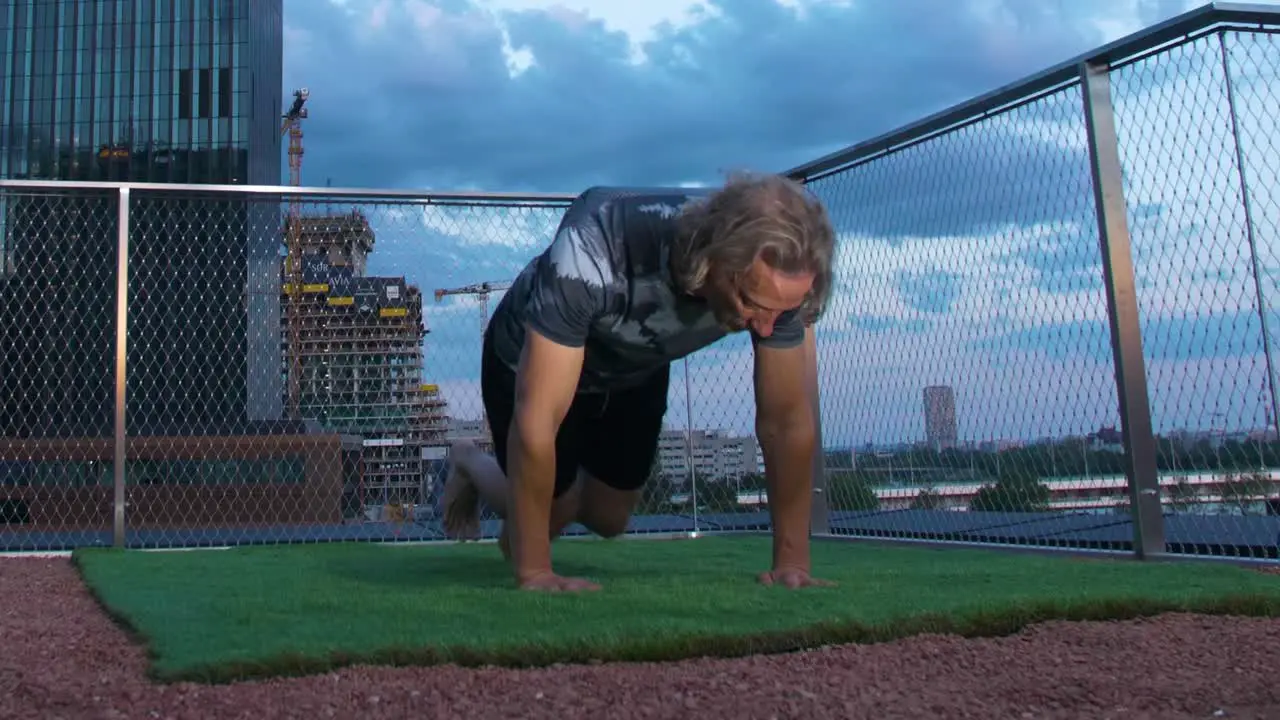 Fitness enthusiast is doing Bicycle Crunches on a chic terrace with Skyline backdrop in Vienna Austria 4K