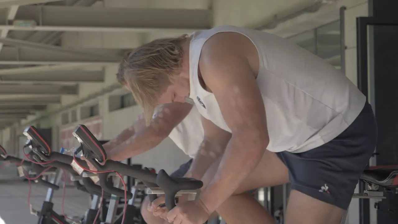 Rugby Players Training on Stationary Bikes in Slow Motion Before a Match