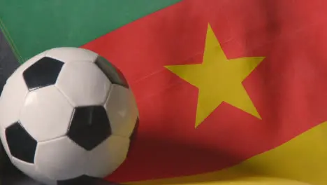 Flag Of Cameroon Draped Over Sofa At Home With Football Ready For Match On TV 3