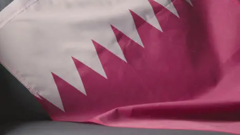 Close Up Of Flag Of Qatar Draped Over Sofa At Home Ready For Match On TV