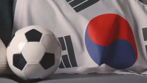 Flag Of South Korea Draped Over Sofa At Home With Football Ready For Match On TV 2