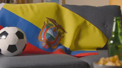 Flag Of Ecuador Draped Over Sofa At Home With Football Ready For Match On TV 1