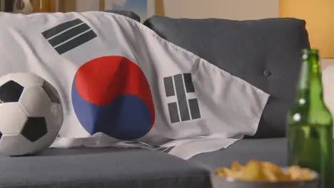 Flag Of South Korea Draped Over Sofa At Home With Football Ready For Match On TV 1