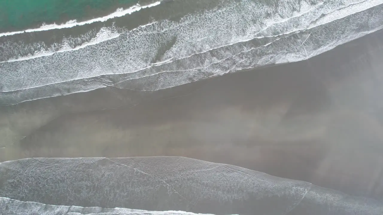 Narrow Whale Tail beach with rainforest in Costa Rica washed by waves