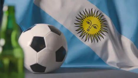 Flag Of Argentina Draped Over Sofa At Home With Football Ready For Match On TV 2