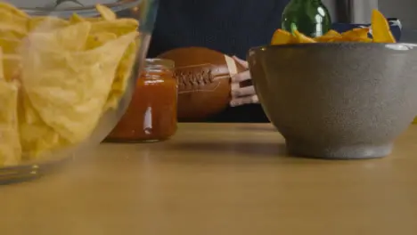 Person At Home Watching American Football Game On TV With Drinks Snacks And Ball 5