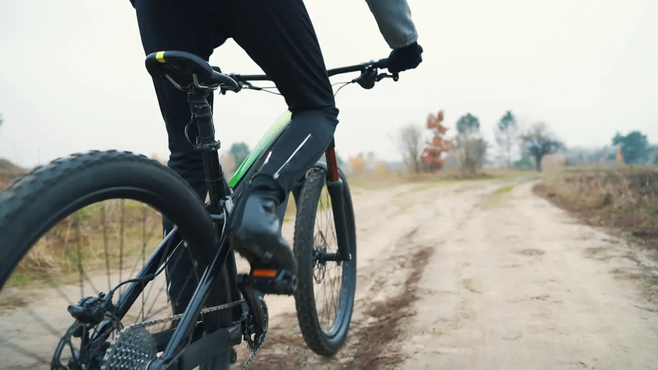 Cyclist Riding A Mountain Bike Down The Road In The Countryside