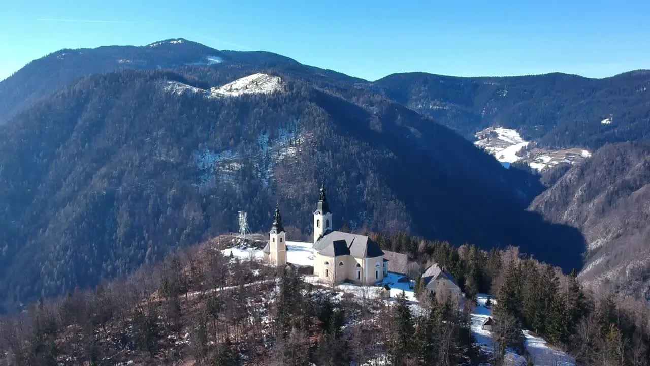 Drone flight above church on top of the mountain in Slovenia