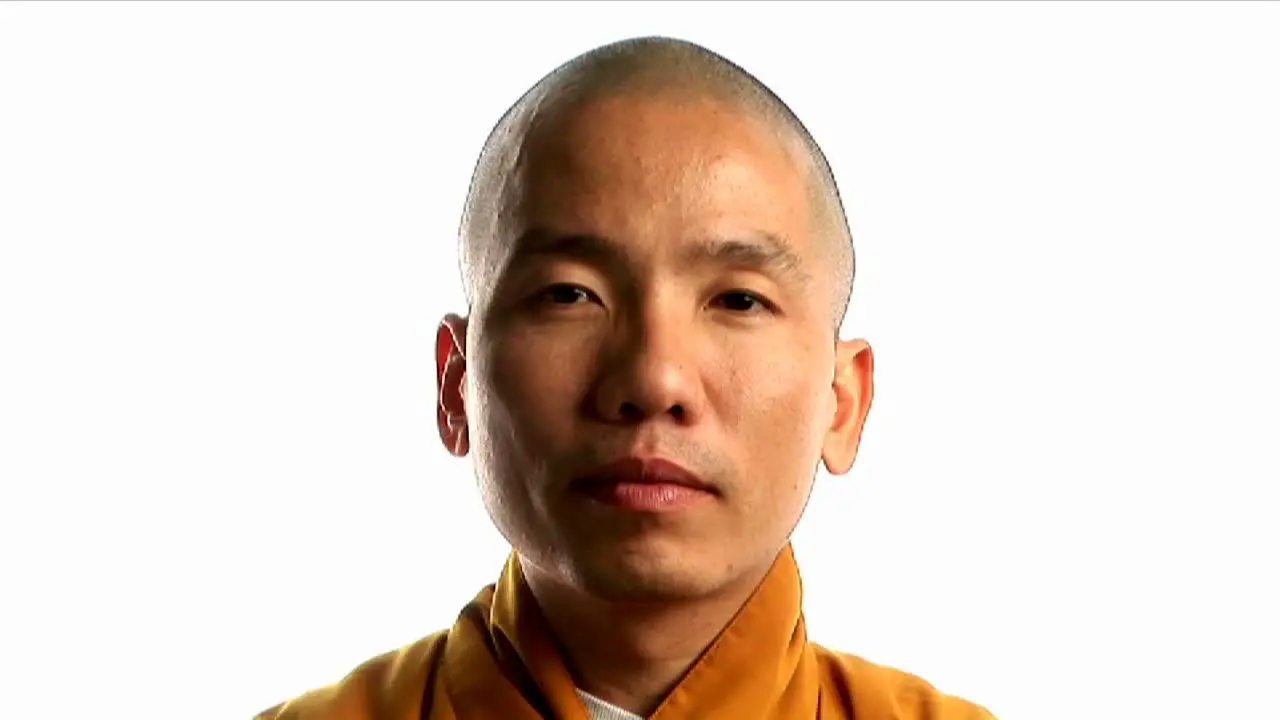 A Buddhist monk wearing an orange robe 