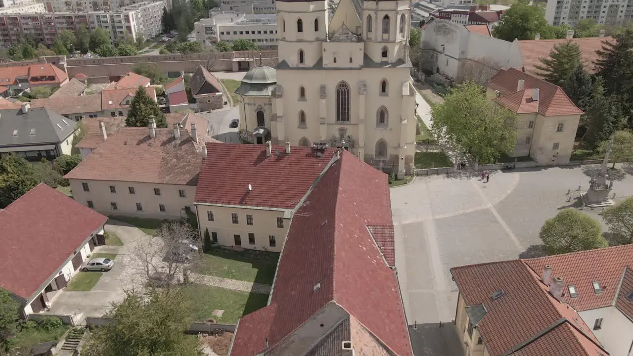 Historical church in Trnava city surrounded by historical buildings