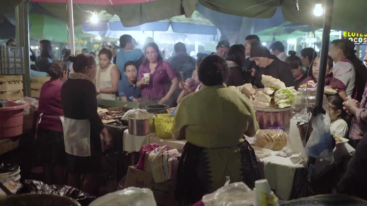 Busy food stalls serve meals to people attending Easter festivities (Semana Santa) in Antigua Guatemala