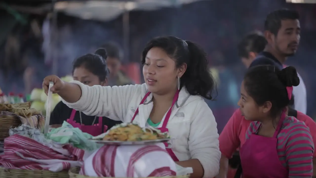 Busy food stalls serve meals to people attending Easter festivities (Semana Santa) in Antigua Guatemala 1