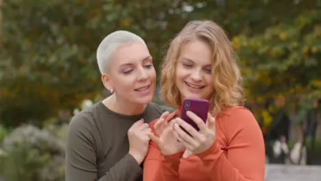 Close Up Shot of Two Female Friends Taking Selfies