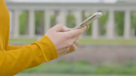 Handheld Shot of Woman Using Phone in Park