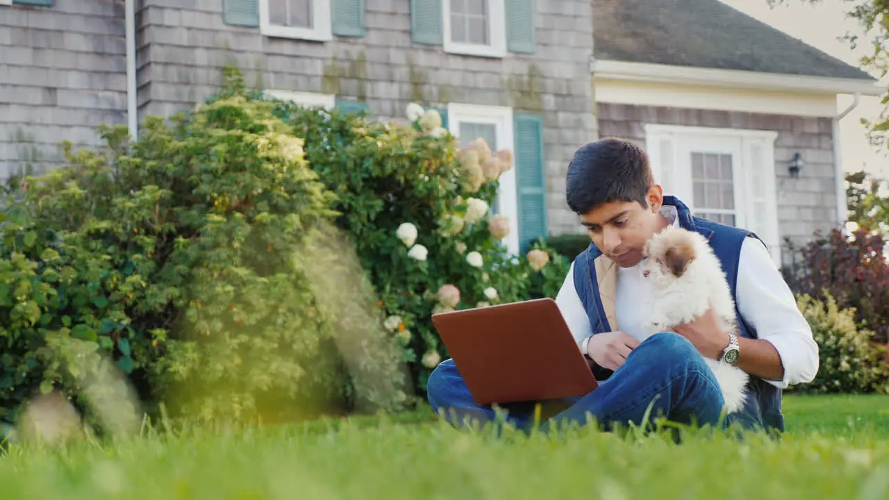 Man With Puppy Using Laptop