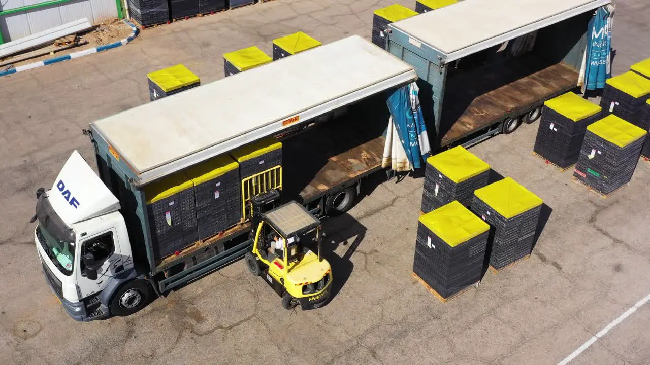 forklift Put cargo pallets into Semi-Trailer Truck orbit aerial shot freight Transport By DAF trucks