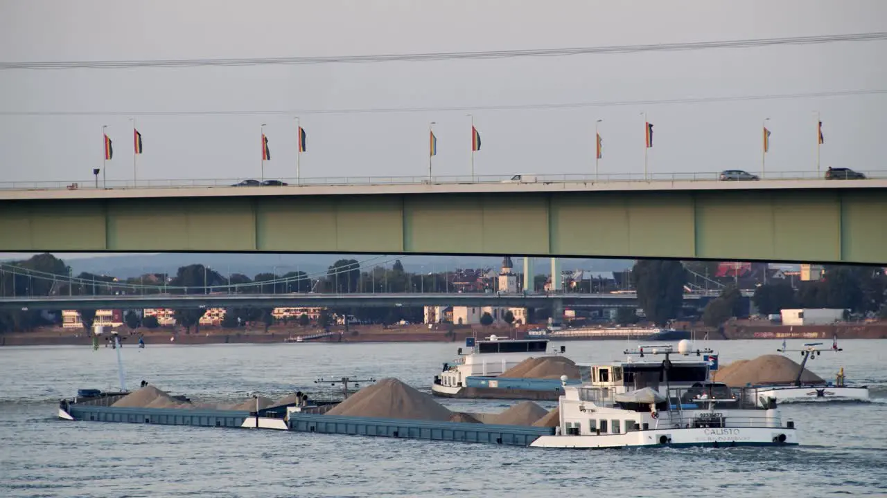 Cologne with Zoo Brücke with cargo ship on river Rhine