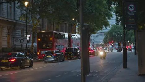 Evening Traffic With Buses And Cars On Busy London England UK Street At Dusk