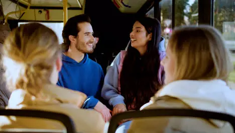 Two young couples sitting in the bus